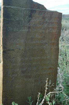 A slate headstone lying flat on Vredendal, cut for a burial of 24 July 1886